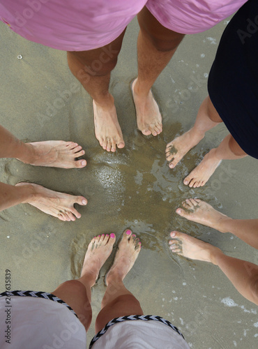 barefeet of a family bathed on the shore photo