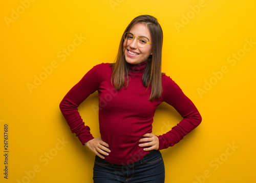 Young intellectual woman with hands on hips