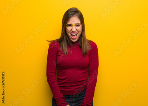 Young intellectual woman screaming very angry and aggressive © Asier