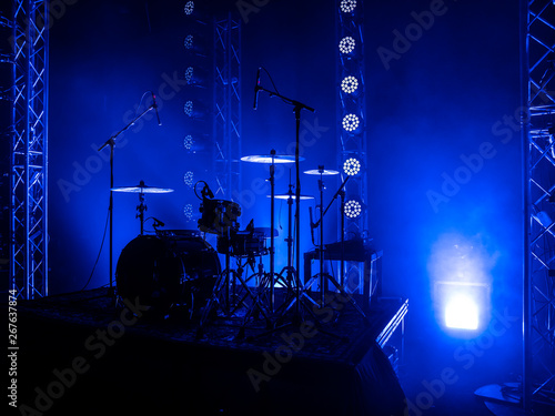 Drum set on the stage of a concert hall or club in a beautiful bright light. Drum set at a rock concert
