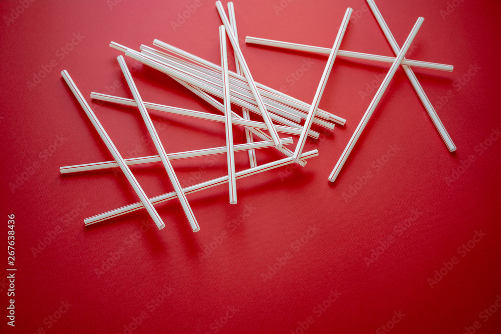 Colorful straw cocktail on red background Colorful straw cocktail on red background
