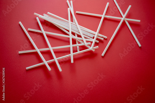 Colorful straw cocktail on red background