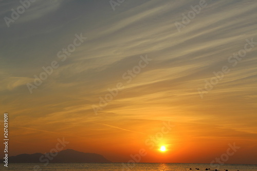  Dawn on the beach. Sun and sea in the early morning. Beautiful seascape.