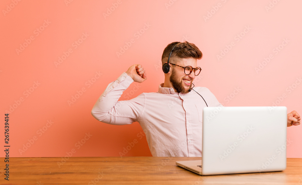 Young man working in a call center dancing and having fun. Young man working in a call center dancing and having fun.