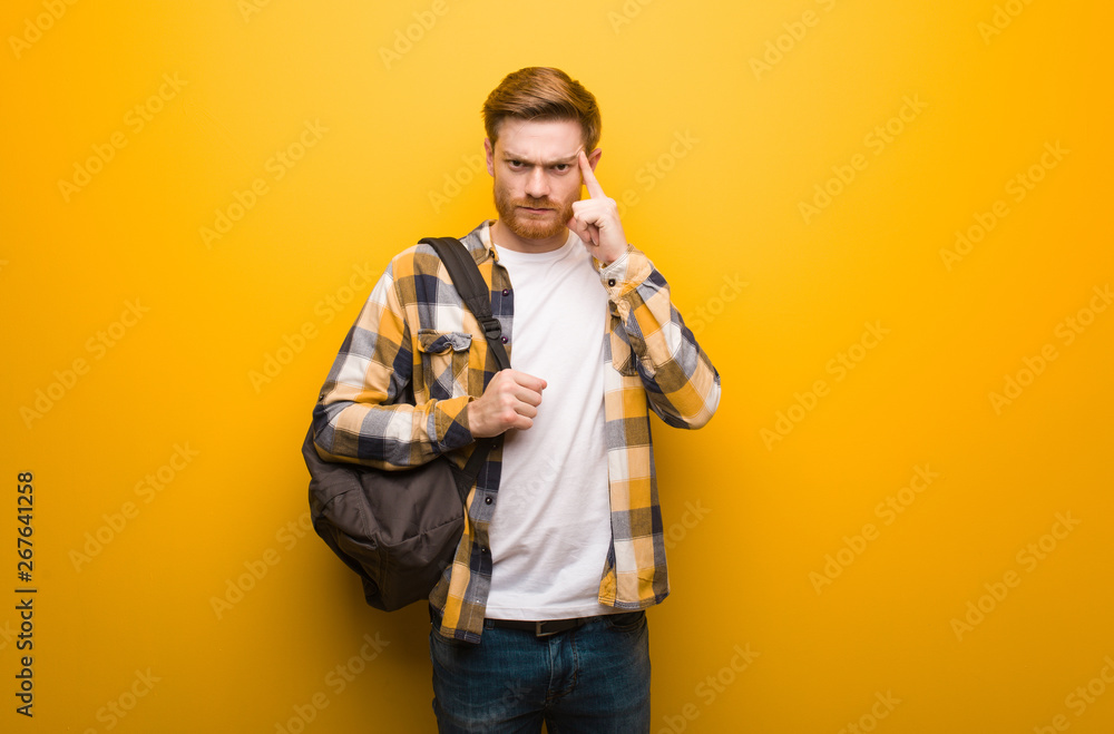 Young redhead student man doing a concentration gesture Young redhead student man doing a concentration gesture
