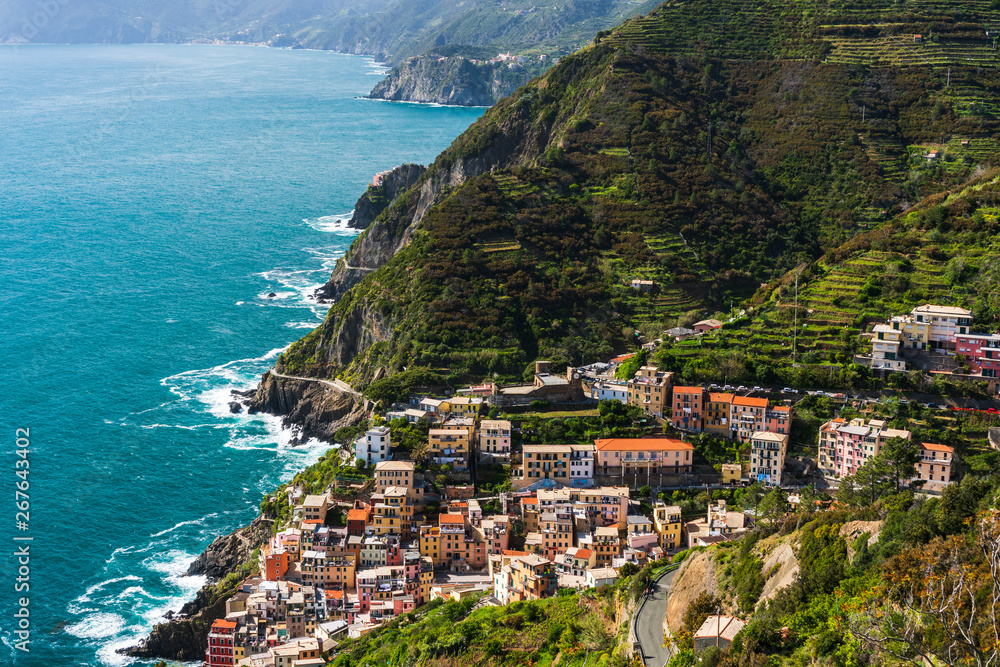 Beautiful Cinque Terre coast landscape with the colorful village of Riomaggiore built at the Ligurian seaside, in Italy.