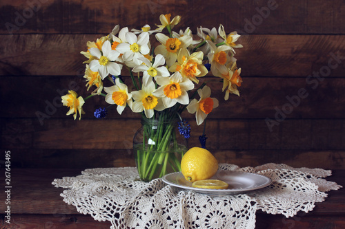 bouquet of yellow garden daffodils and lemon, still life with spring flowers