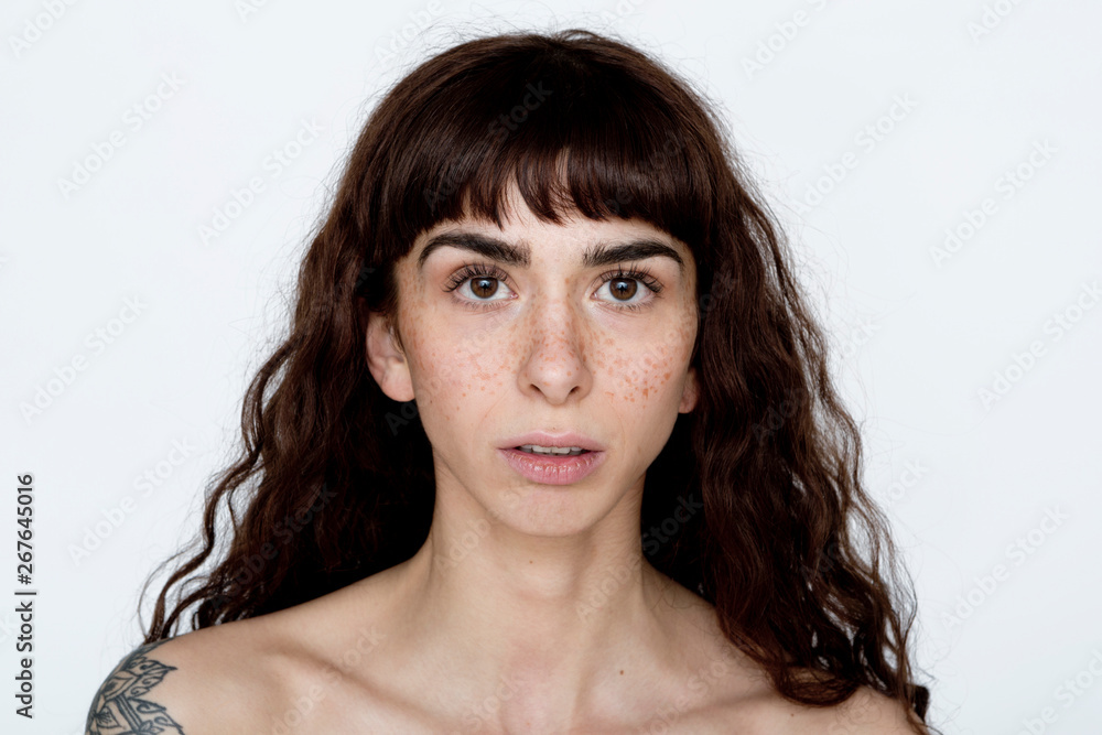 Portrait of tattooed young woman with freckles Portrait of tattooed young woman with freckles