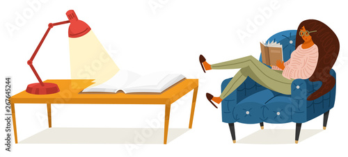 A fan of books a woman is sitting on the couch. Stylish literature lover with glasses. A table for learning.