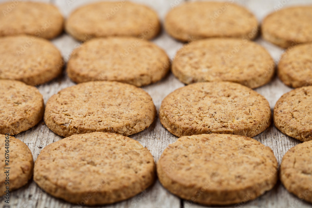 Fresh baked oat cookies closeup on rustic wooden table background. Fresh baked oat cookies closeup on rustic wooden table background.