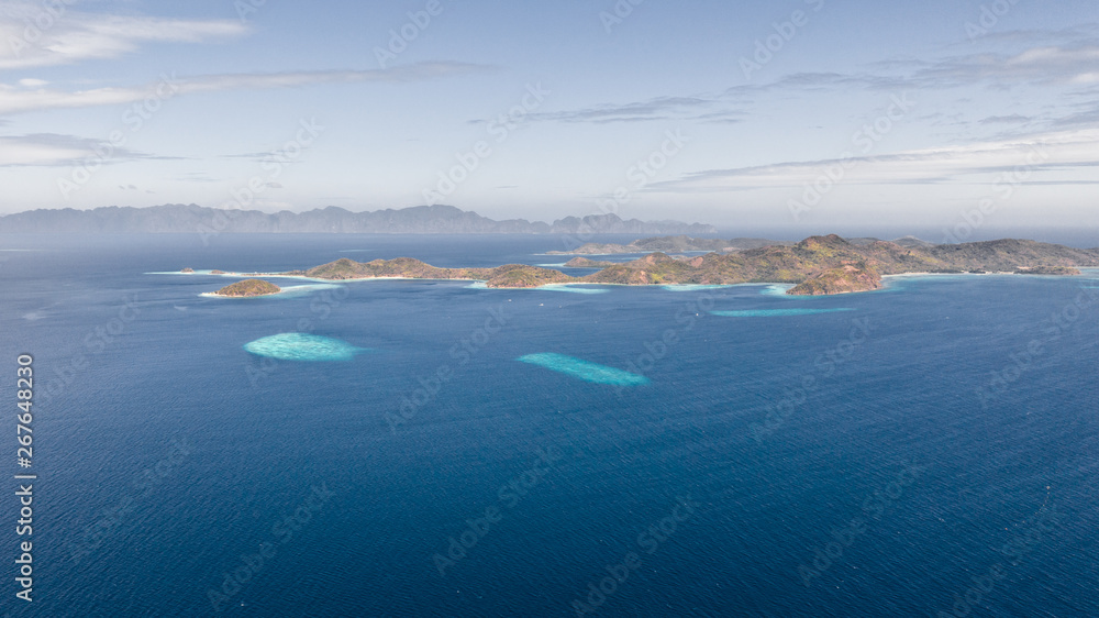 aerial view tropical islands with blue lagoon, coral reef and sandy beach. Palawan, Philippines. Islands of the Malayan archipelago with turquoise lagoons. aerial view tropical islands with blue lagoon, coral reef and sandy beach. Palawan, Philippines. Islands of the Malayan archipelago with turquoise lagoons.