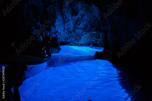 Tourists inside Blue cave, Bisevo island - Croatia. 