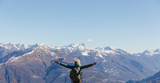 Italy, Como, woman on a hiking trip in the mountains enjoying the view