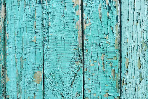 The background and texture of the painted blue boards with old and cracked paint..