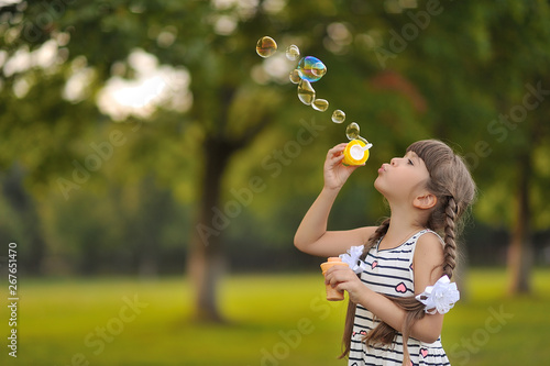 Cute girl with soap bubbles