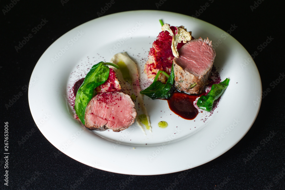 Beef steak with mashed potatoes decorated with greens on a white plate. Beef steak with mashed potatoes decorated with greens on a white plate.
