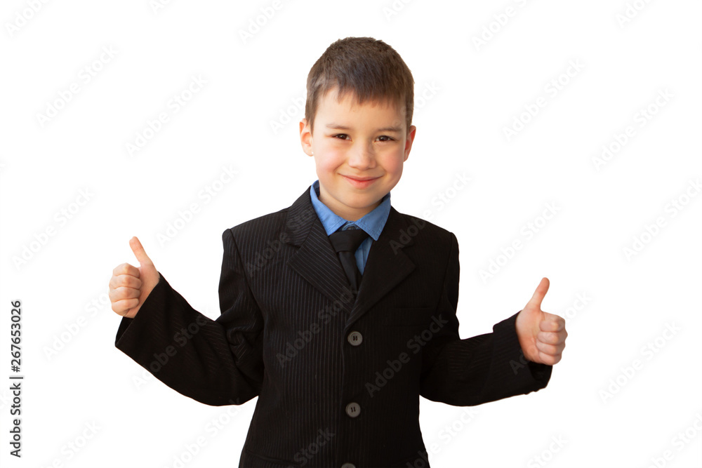 boy, schoolboy, in black business suit shows two hands a class, with a smile on his face boy, schoolboy, in black business suit shows two hands a class, with a smile on his face