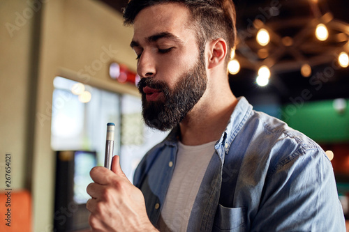 Portrait of man preparing his billiards cue photo