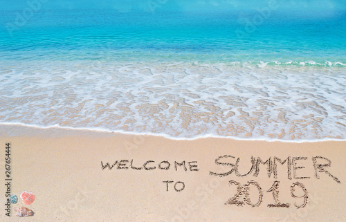 welcome to summer 2019 written on the sand