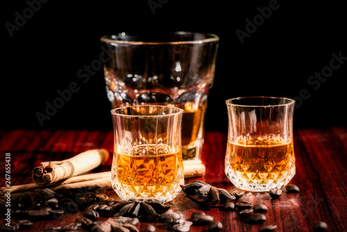 Brandy or liquor,Set of strong alcoholic drinks in glasses and shot glass on dark wood background © kingrobert