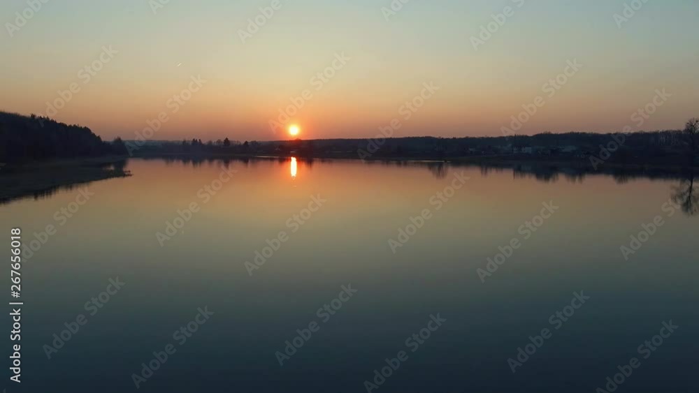 River in sunset. Low flight of the drone over the smooth surface of the water with reflection. Nature resources and environment of Earth. Aerial survey view. Flight of drone River in sunset. Low flight of the drone over the smooth surface of the water with reflection. Nature resources and environment of Earth. Aerial survey view. Flight of drone
