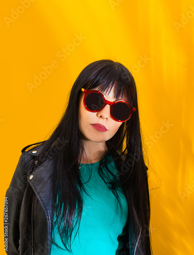 Portrait upset girl woman sunglasses background yellow sad grief sorrow brunette shadow sun light tropical leaves