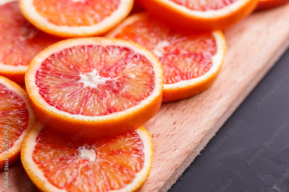 Blood orange cut in circles on a dark background Blood orange cut in circles on a dark background