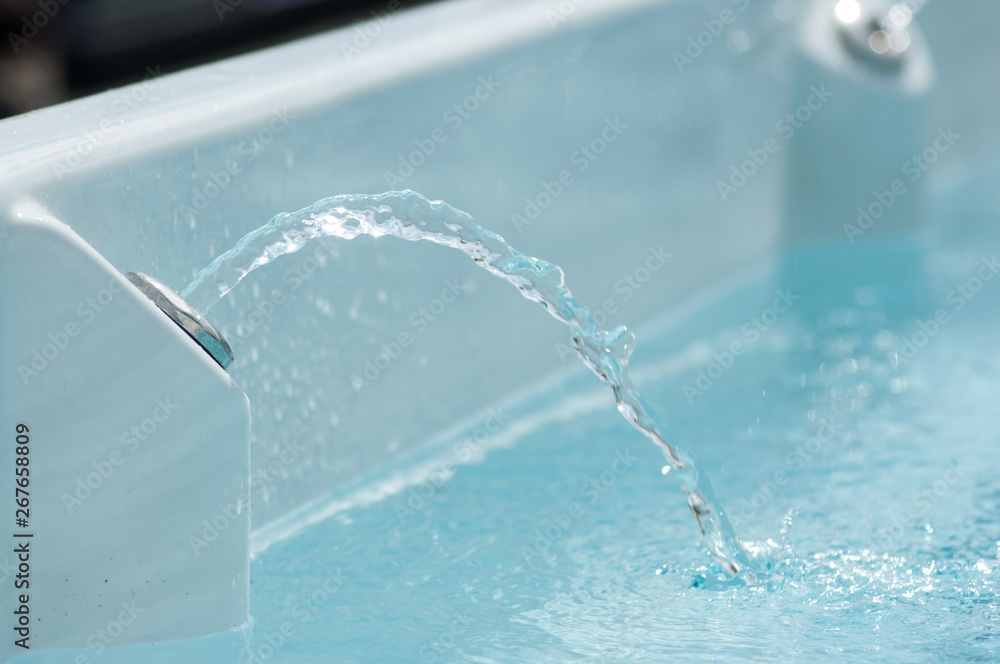 closeup of jet of water in swirl bath closeup of jet of water in swirl bath