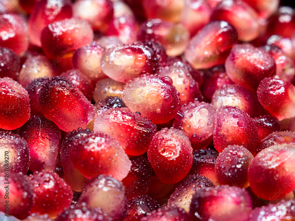 Macro shot of fresh pomegranate seeds with water droplets. Macro shot of fresh pomegranate seeds with water droplets.