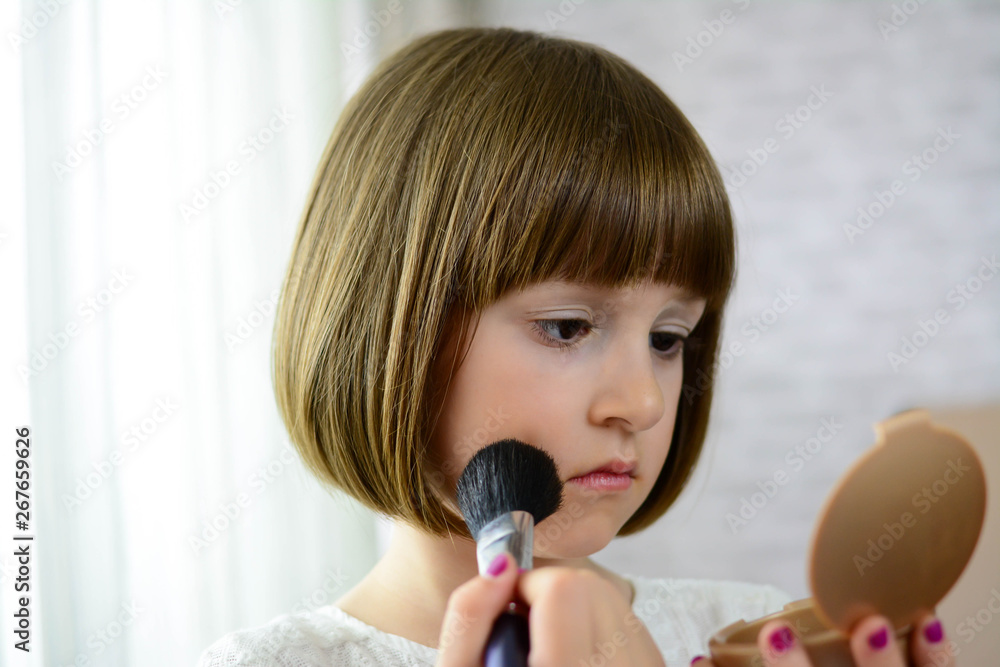 Fashion little girl applying make up. Preschool girl doing makeup. Fashion little girl applying make up. Preschool girl doing makeup.