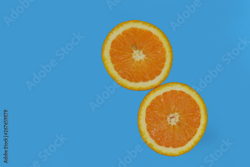 two half ripe orange fruit 