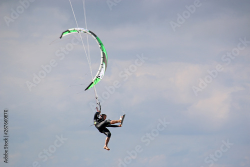 kitesurfer jumping with his board