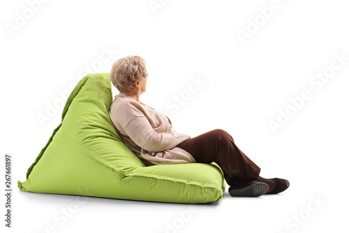 Senior woman sitting on a bean bag and looking away