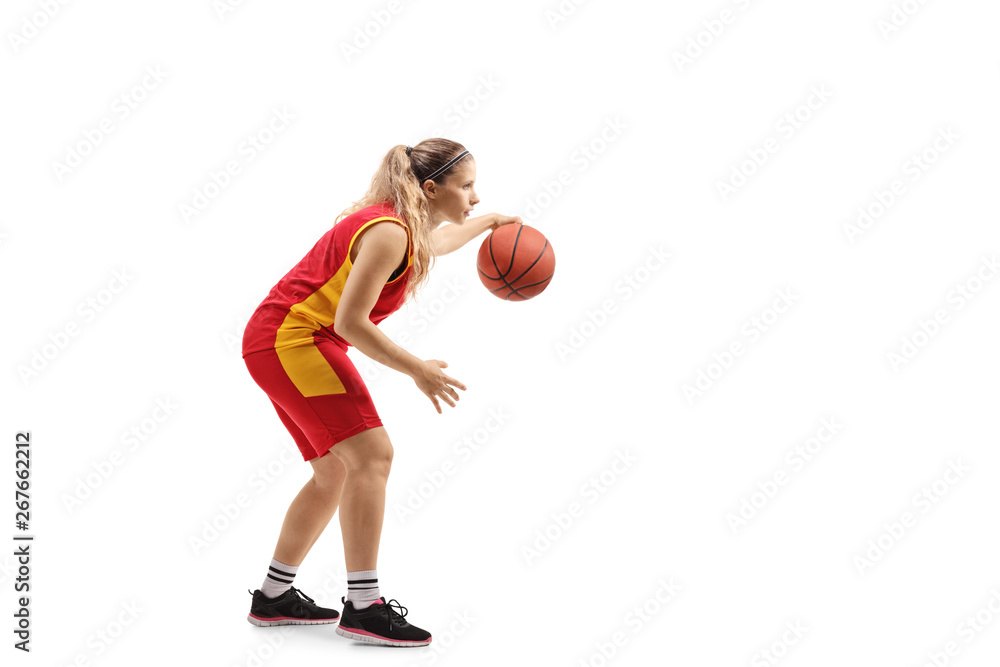 Female basketball player leading a ball