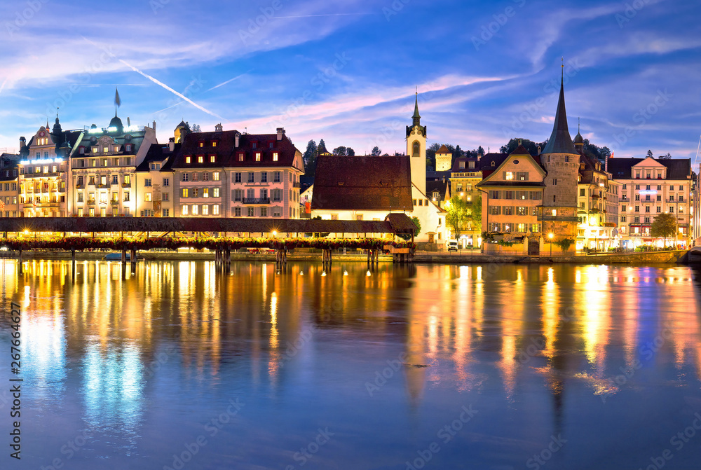 Luzern Kapelbrucke and riverfront architecture famous Swiss landmarks evening view
