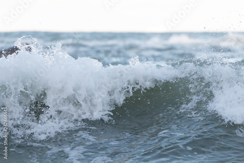 Wave crashing down with white splash of foam © Alexisaj