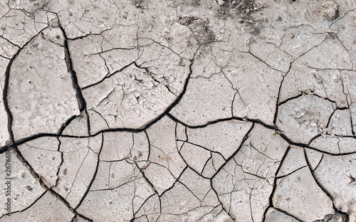 Dry cracked ground. Natural background. Chernozem and agriculture in the period of extreme drought. The texture of the desert close up.