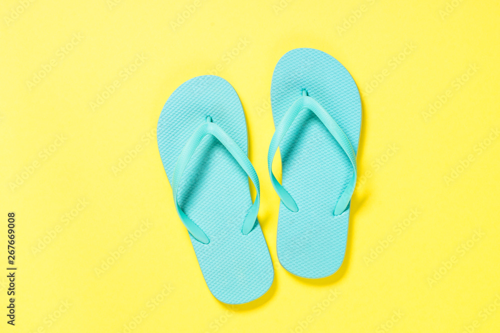 Blue flip flops on yellow background. Blue flip flops on yellow background.