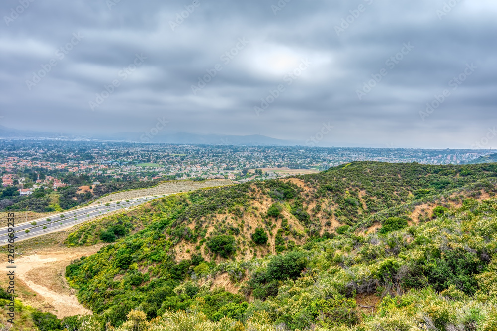 city below forest in southern california on cloudy spring day