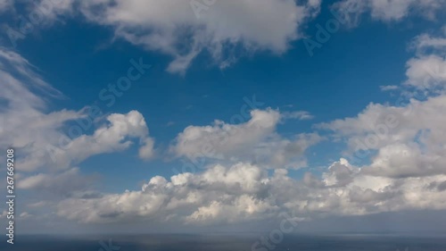 HD Time lapse of white summer clouds over ocean horizon Cloud running across the blue sky background photo