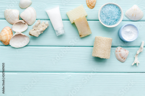 organic cosmetic set with Dead Sea salt, cream and lotion on mint green wooden background top view mock up