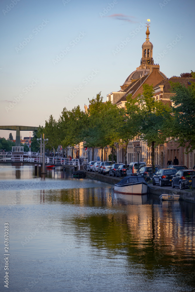 Obraz premium Reflection of Traditional Dutch facades, church tower and canal street