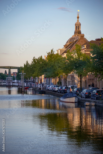 Reflection of Traditional Dutch facades, church tower and canal street