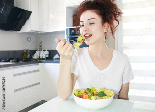 Beautiful young woman eating healthy food