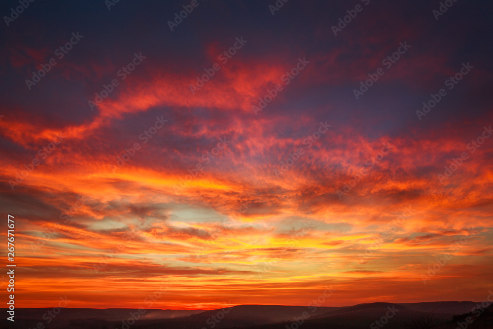 Gorgeous orange sunset colorful clouds in evening sky, natural beauty of nature