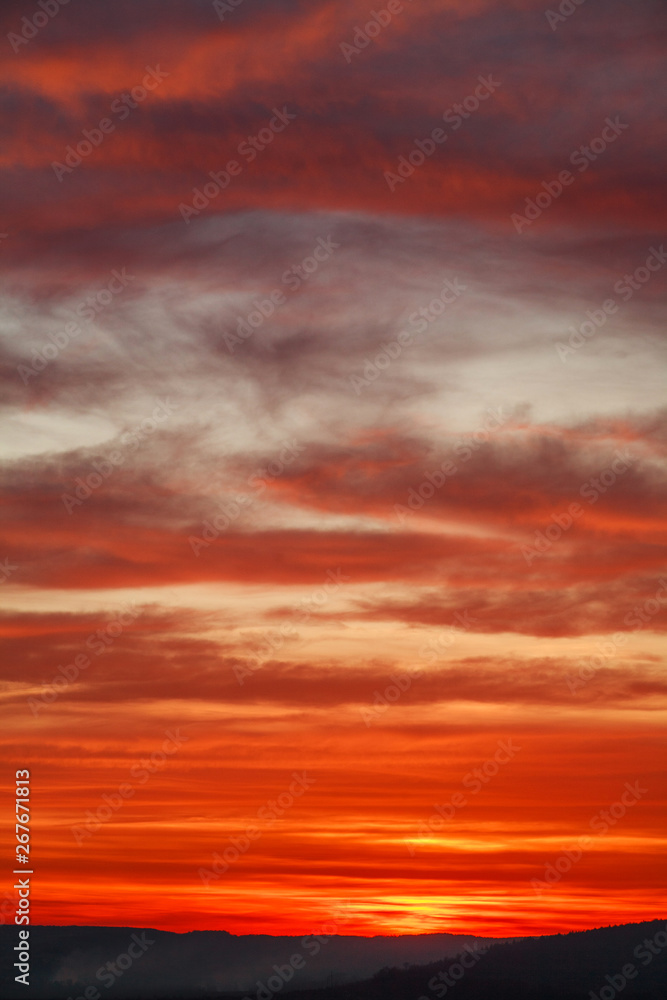 Gorgeous orange sunset colorful clouds in evening sky, natural beauty of nature