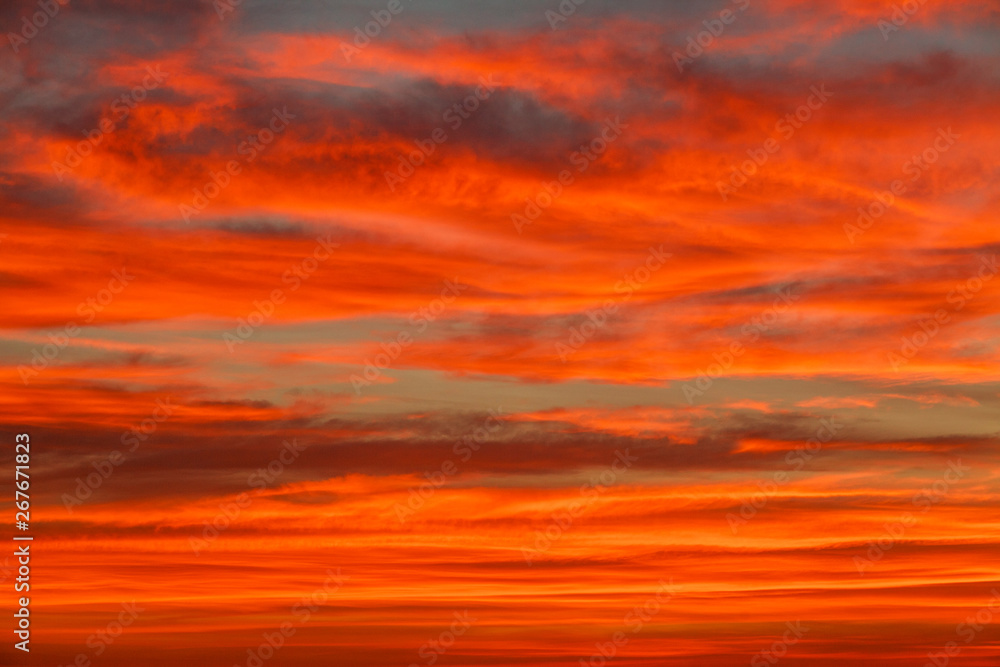 Gorgeous orange sunset colorful clouds in evening sky, natural beauty of nature