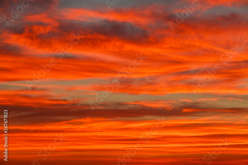 Gorgeous orange sunset colorful clouds in evening sky, natural beauty of nature