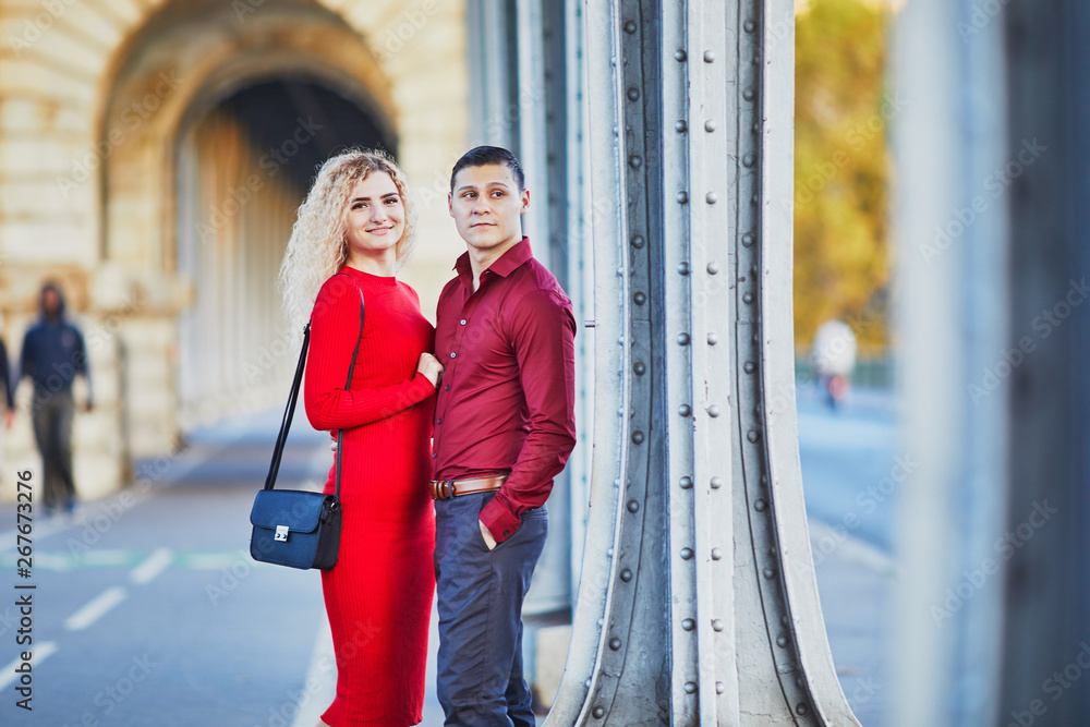 Romantic couple walking on Bir-Hakeim bridge in Paris, France