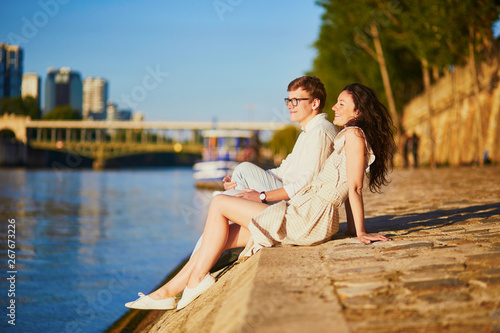 Happy romantic couple in Paris, near the river Seine